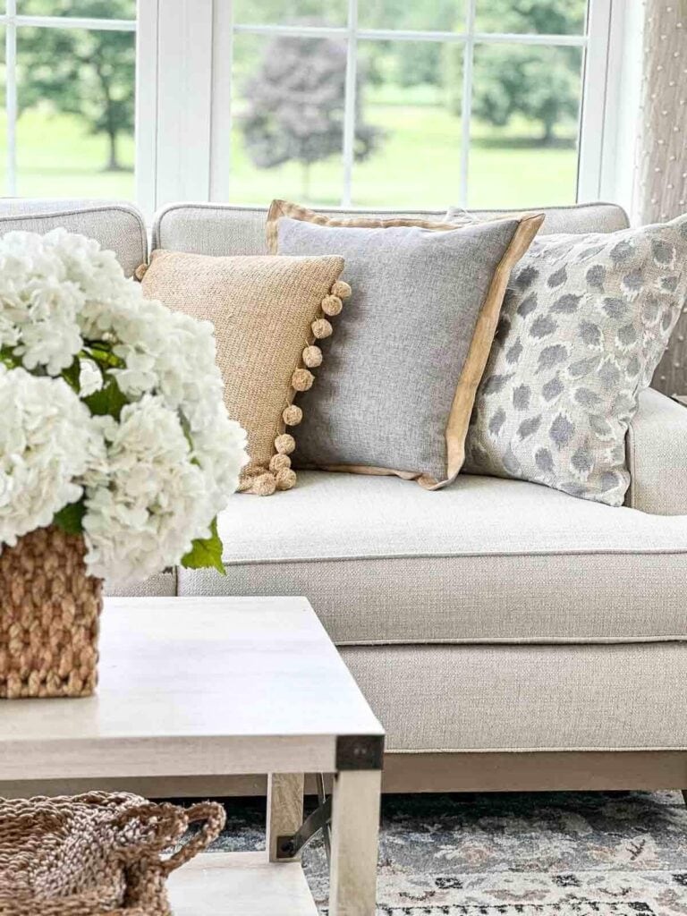 neutral sofa with pillows showing a mix of warm and cool undertones in decorating