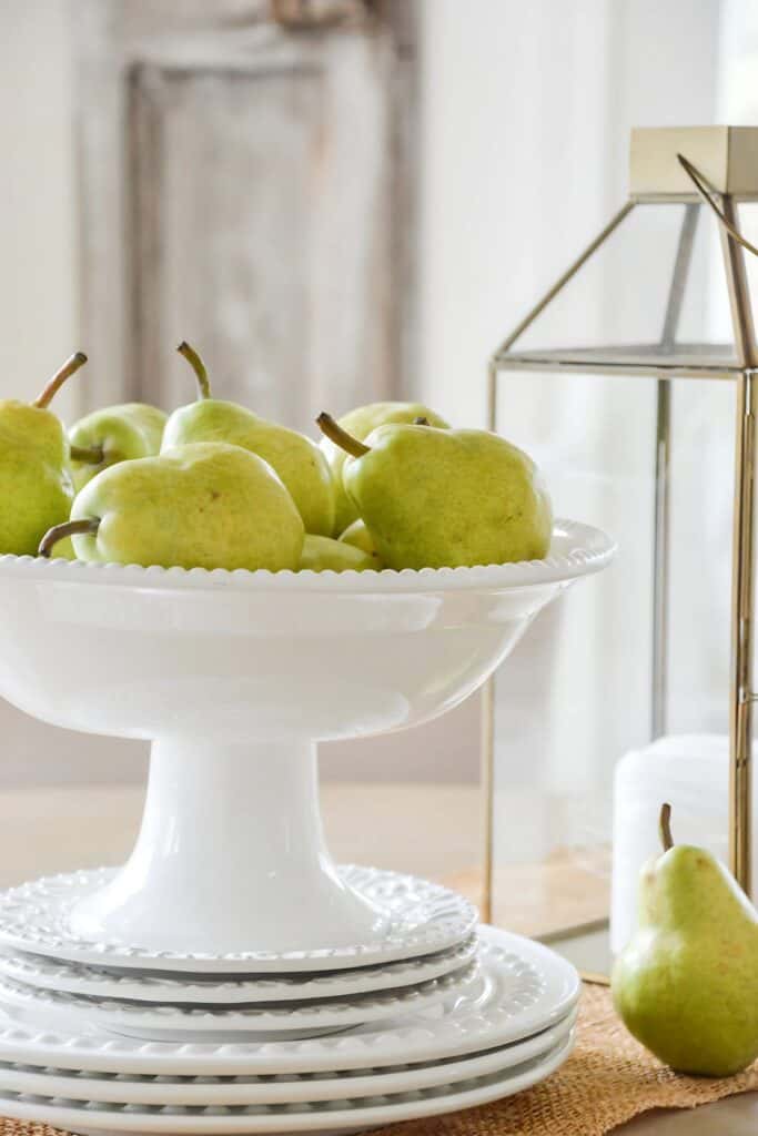 pears in a white pedestal bowl