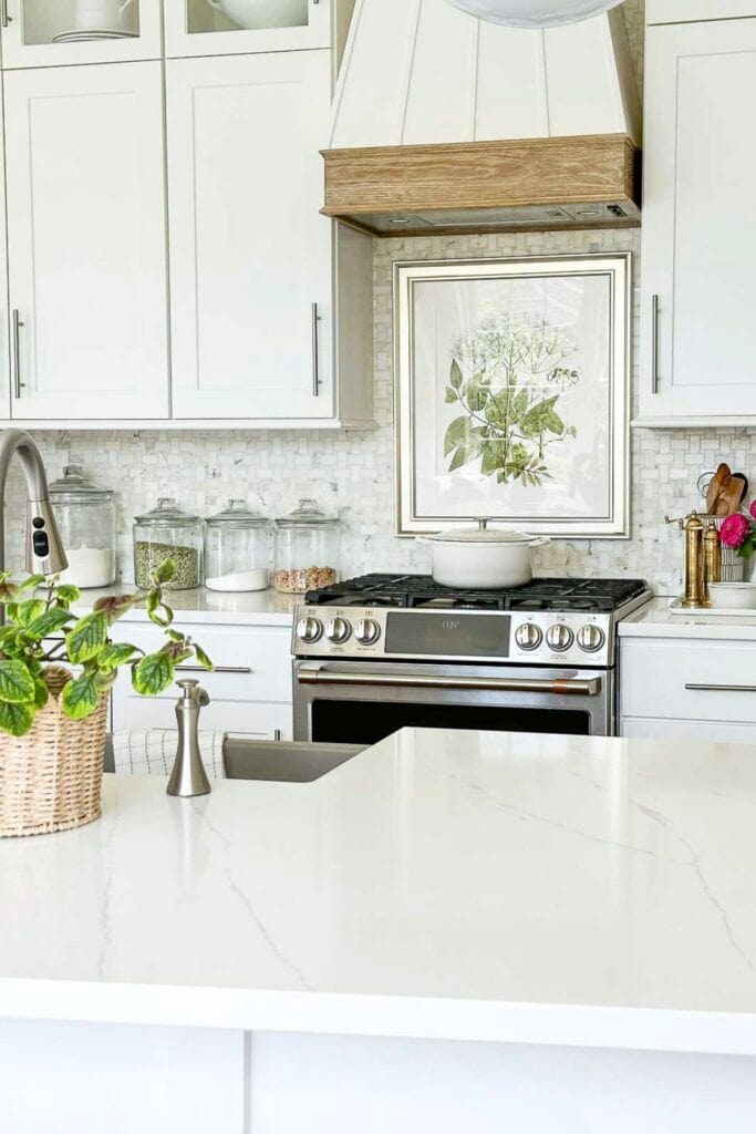 White kitchen with large picture above the stove