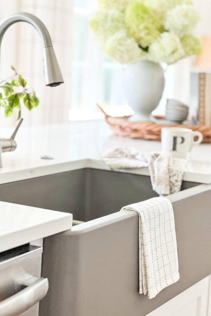 towel folded on the edge of a kitchen sink