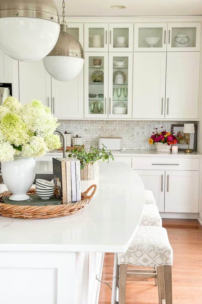 vignette with a vase of limelight hydrangeas and kitchen in the background