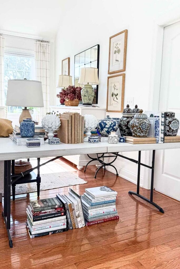 decor, books, and keepsakes on a table ready to be placed in a bookshelf