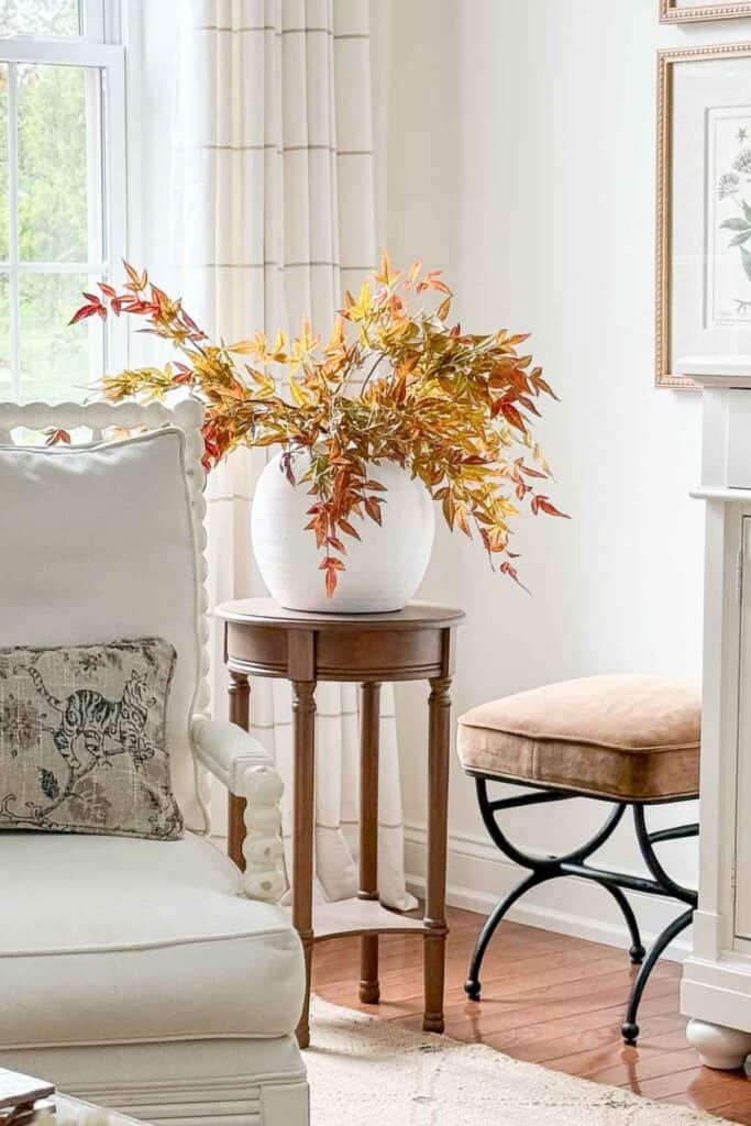 faux fall branches in a white bowl vase
