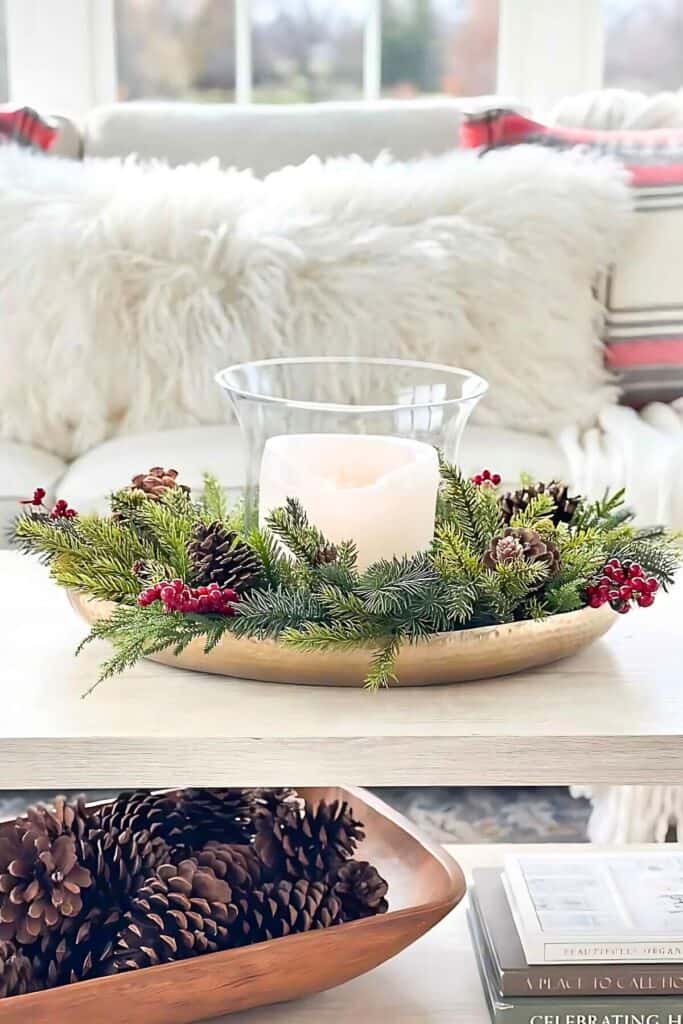 layered textures with greenery, pinecones, faux fur, and a gold tray centerpiece for a cozy holiday look.