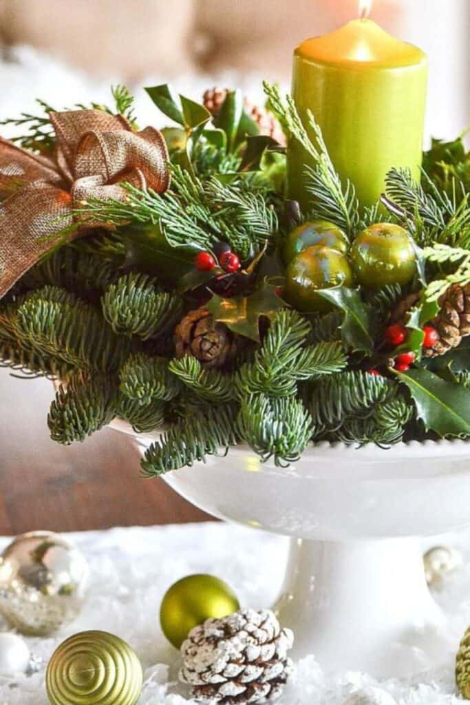 footed bowl with a wreath and a candle in it