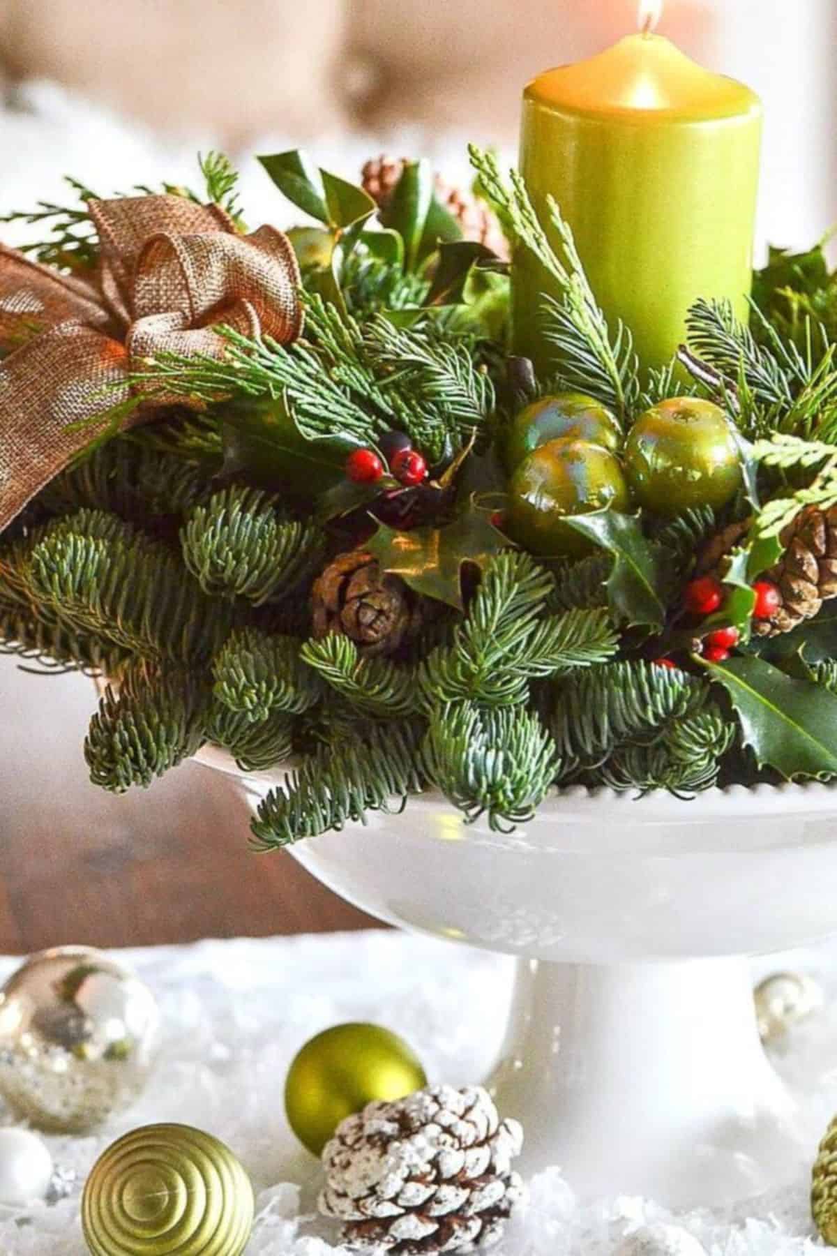 Christmas arrangement- a white footed bowl, a wreath used as a candle ring and a candle