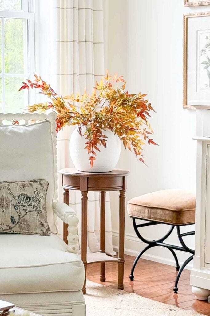 saturated fall leaves in a white bowl vase