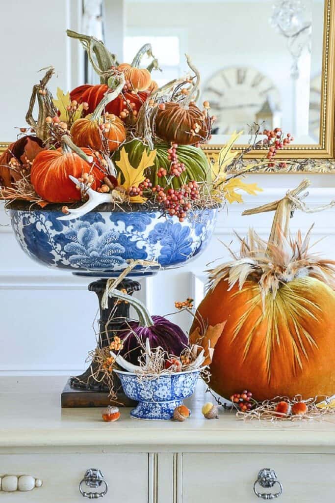 velvet pumpkins in a blue and white compote bowl