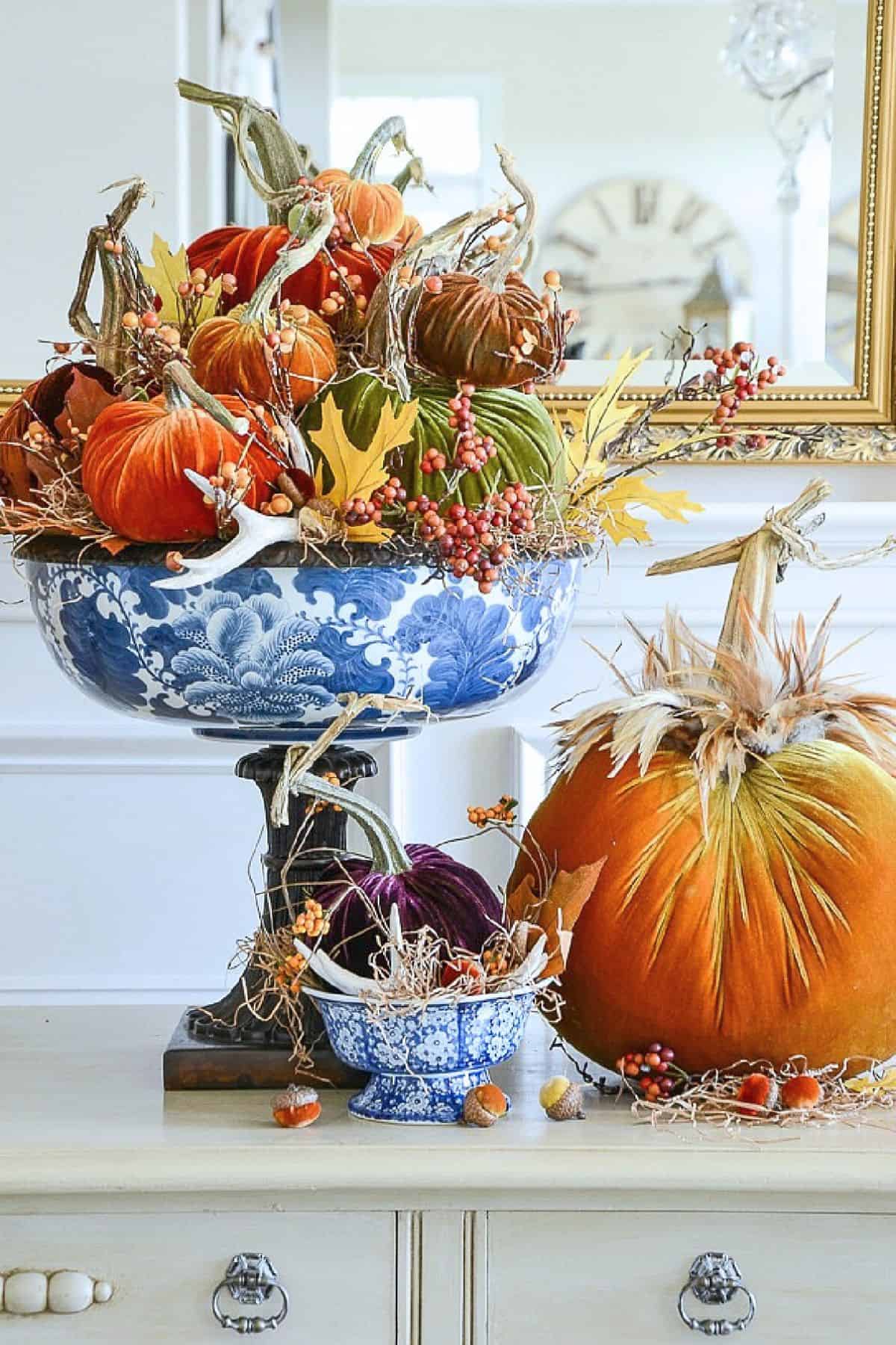 velvet pumpkins in a blue and white compote bowl
