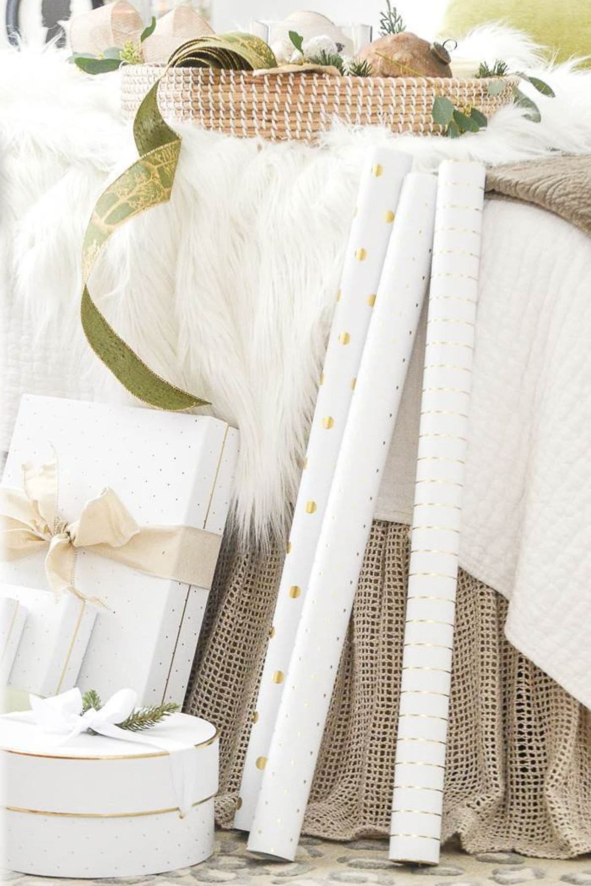 Christmas presents and gift wrapped leaning against a bed
