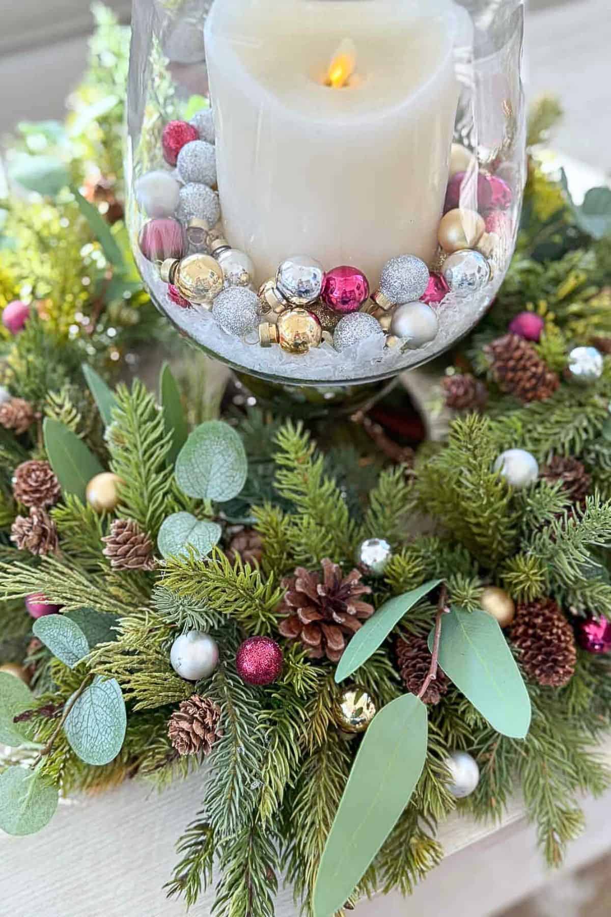 wreath make into a candle ring with tiny Christmas balls scattered through it