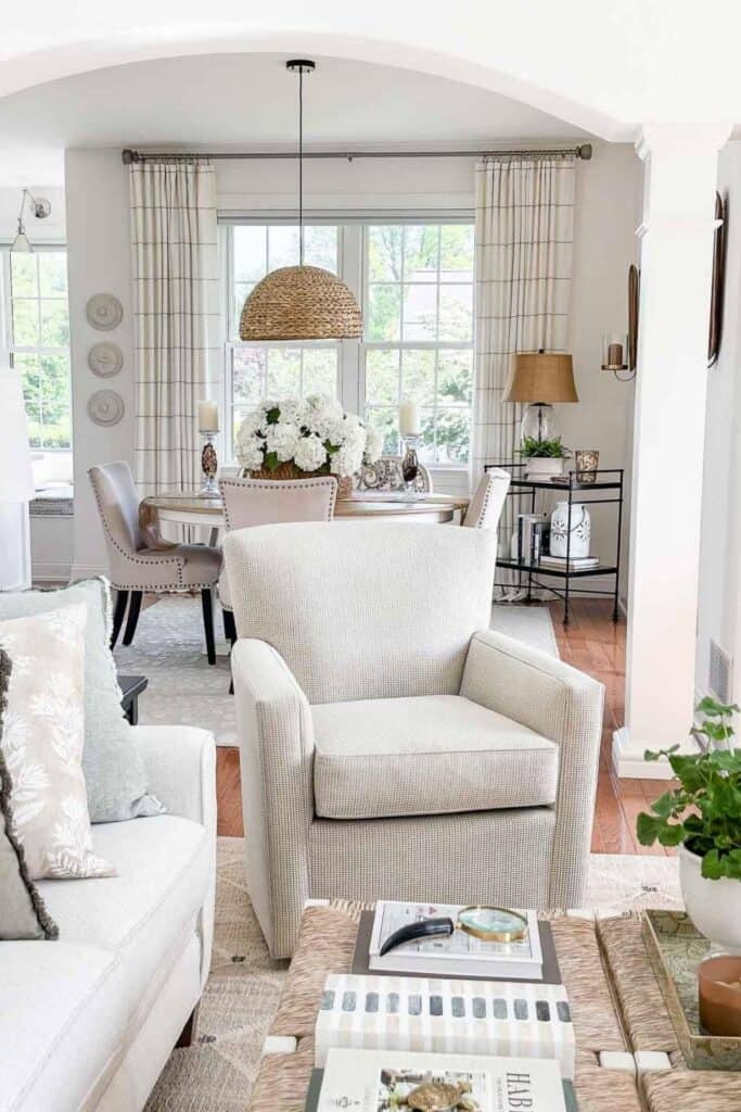 a chair in the living room looking into the dining room