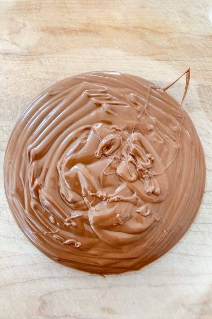 Melted milk chocolate and butterscotch chips for no bake haystack cookies