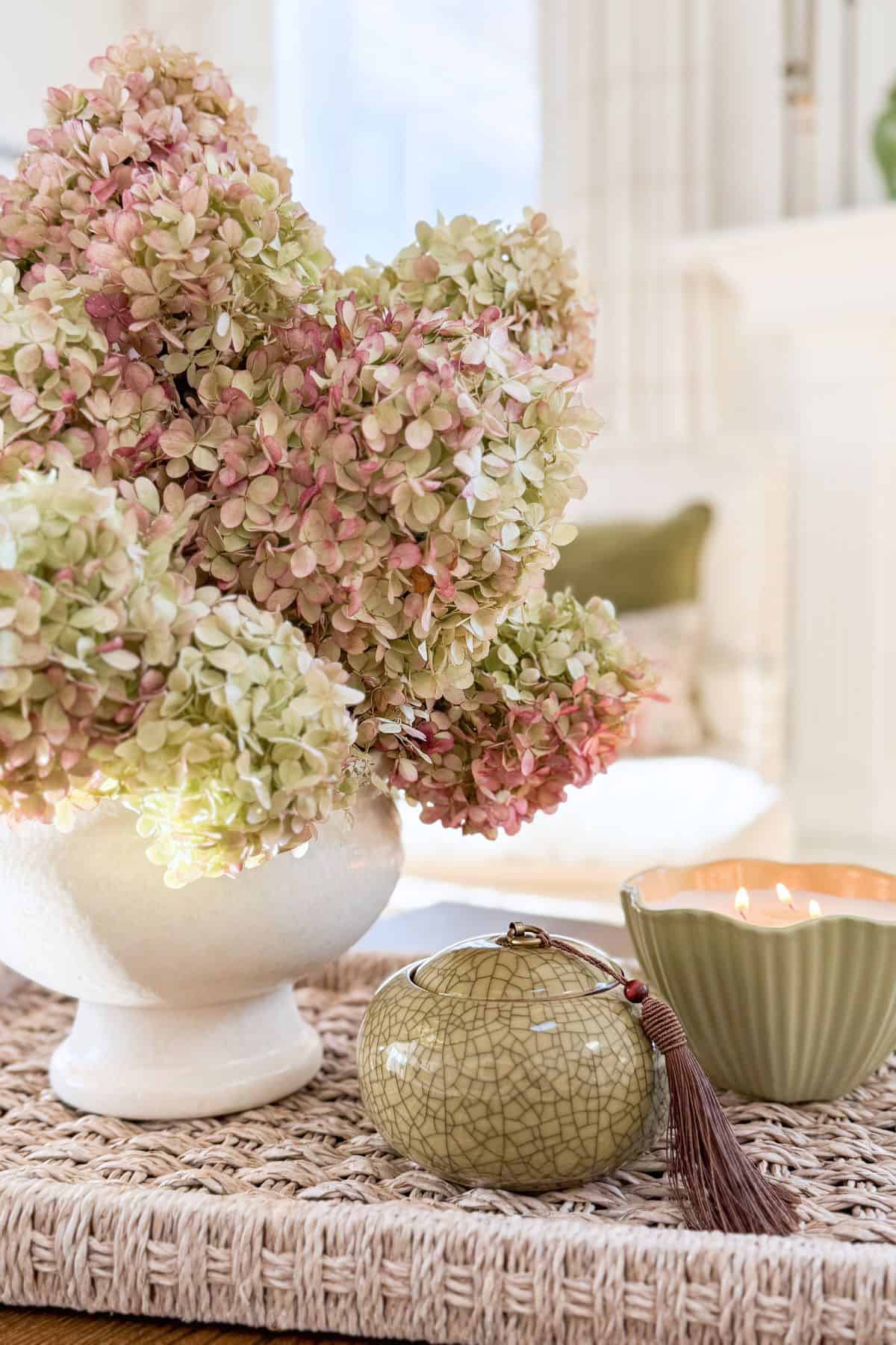 close-up of hydrangeas in a vignette anchored by a low-sided basket