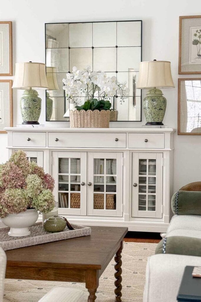 lamps on either side of a white buffet in the living room