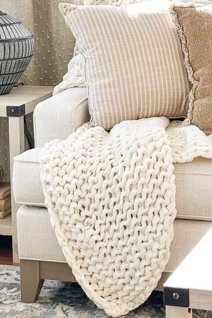 pillows and a cozy throw on a sofa