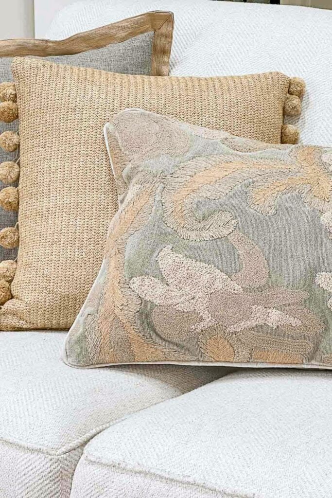 pillows on a sofa with a soft color palette