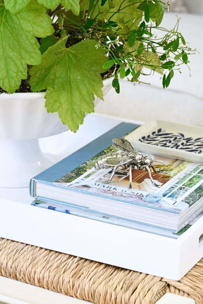 a silver bee on favorite books on a tray in the living room