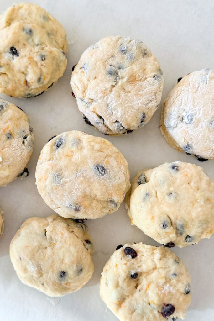 uncooked Irish soda bread scones with currants cut and ready to bake on parchment paper