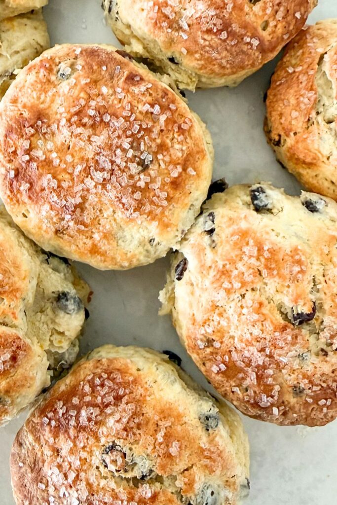 homemade Irish soda bread scones with currants and sanding sugar on a white serving plate