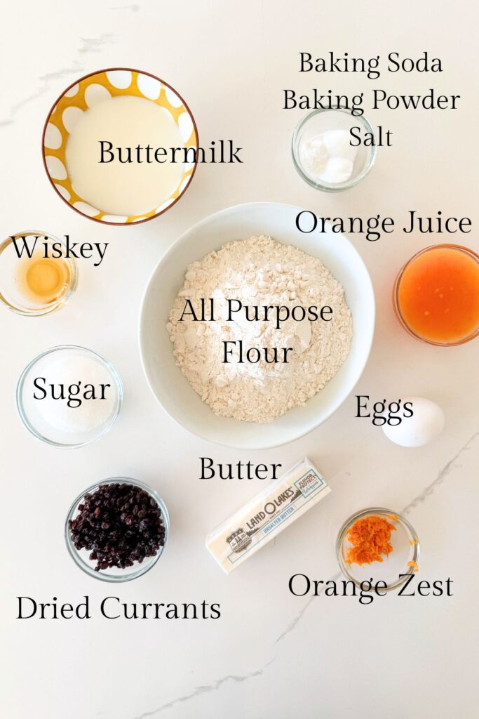 ingredients for Irish soda bread scones including flour, buttermilk, butter, currants, orange zest, and sugar