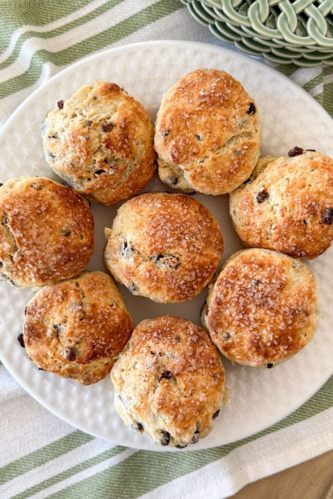 golden Irish soda bread scones with currants and sanding sugar on a white plate