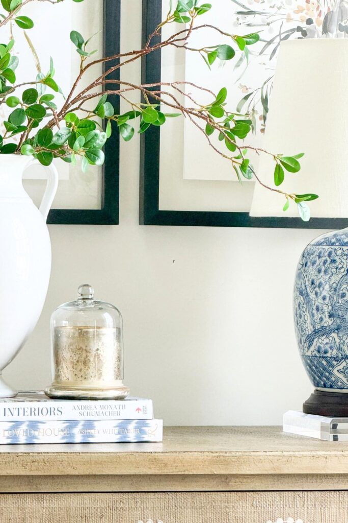 blue and white dishes layered with mixed patterns and small floral accent on table