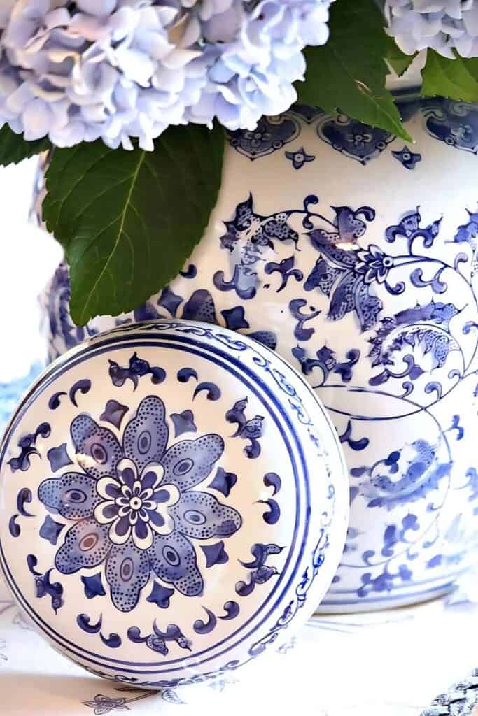 blue and white ceramic vase and plate with detailed pattern and hydrangeas