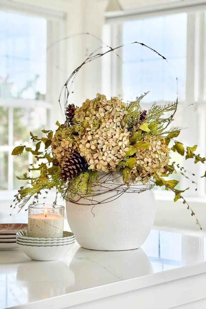 kitchen island styled with dried hydrangeas greenery and candle in a simple fall centerpiece