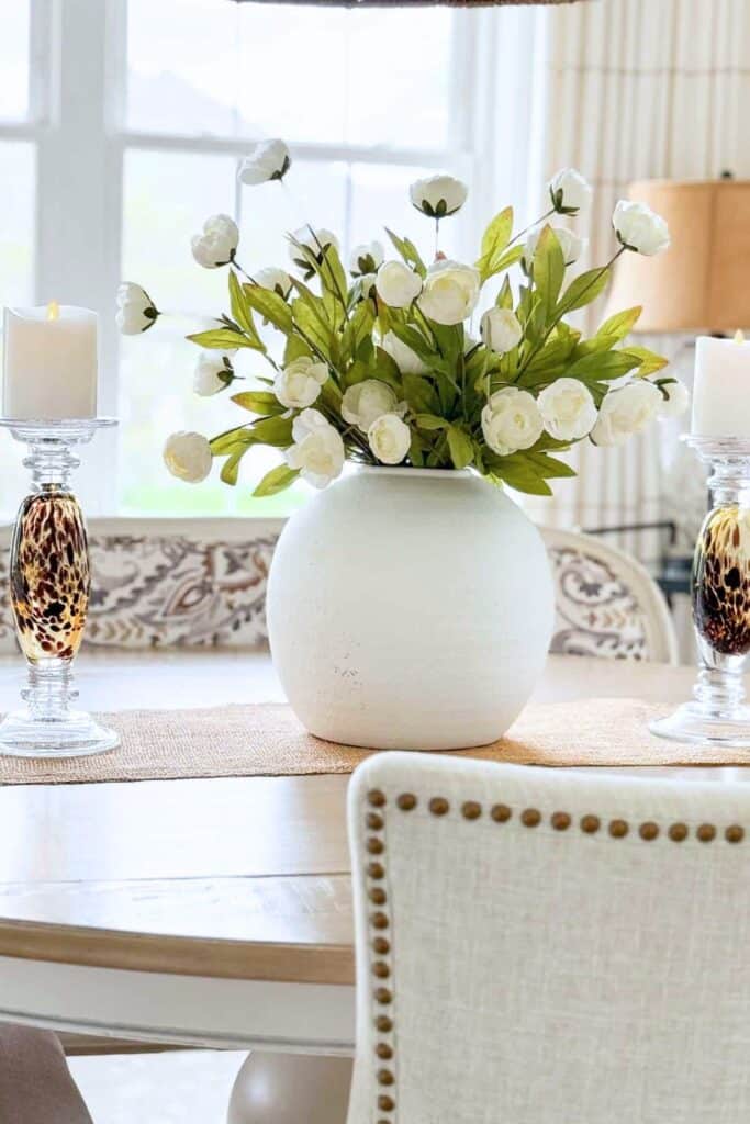 round vase with fluffy white flowers