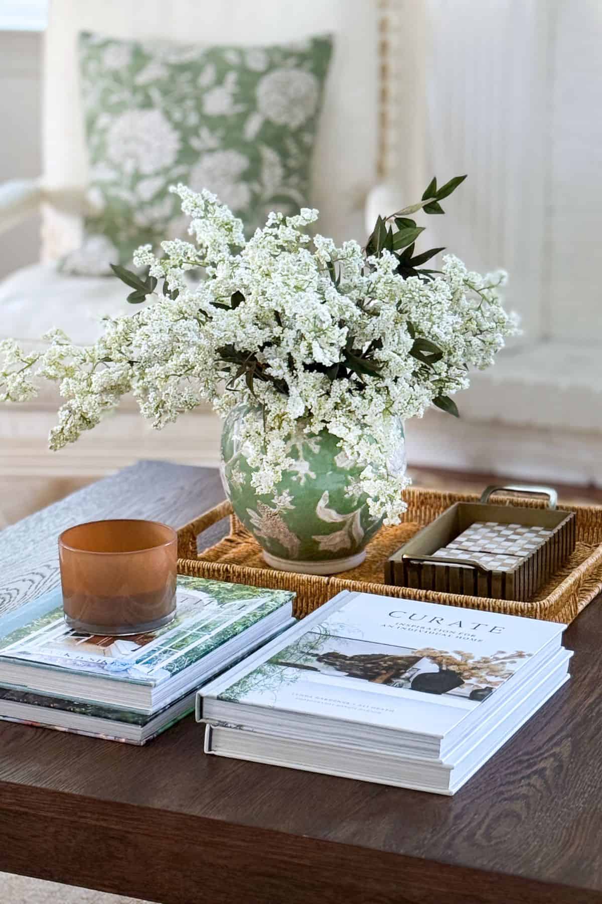green and white chinoiserie vase filled with white fluffy flowers