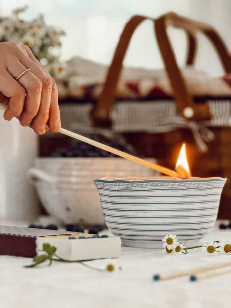 blue and white striped candle bowl being lit