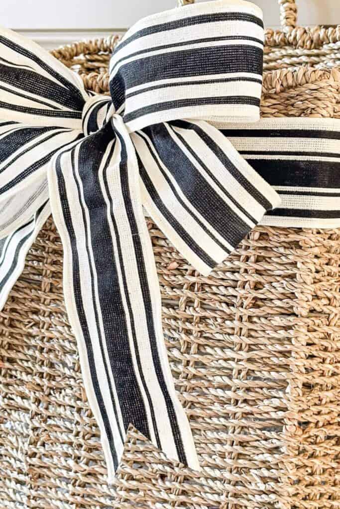 Black and white striped ribbon bow on woven door basket for summer decorating