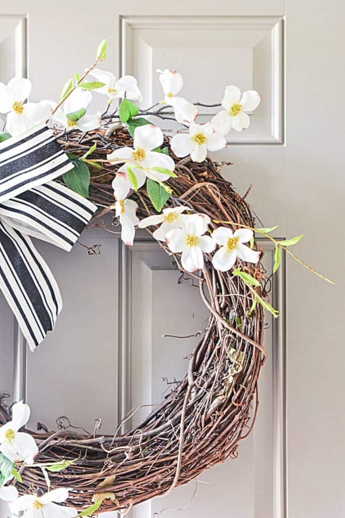 Dogwood wreath on grapevine base with ribbon for summer front door decor