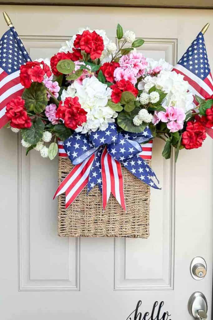 Patriotic red white and blue front door basket with flowers and ribbon for summer decorating