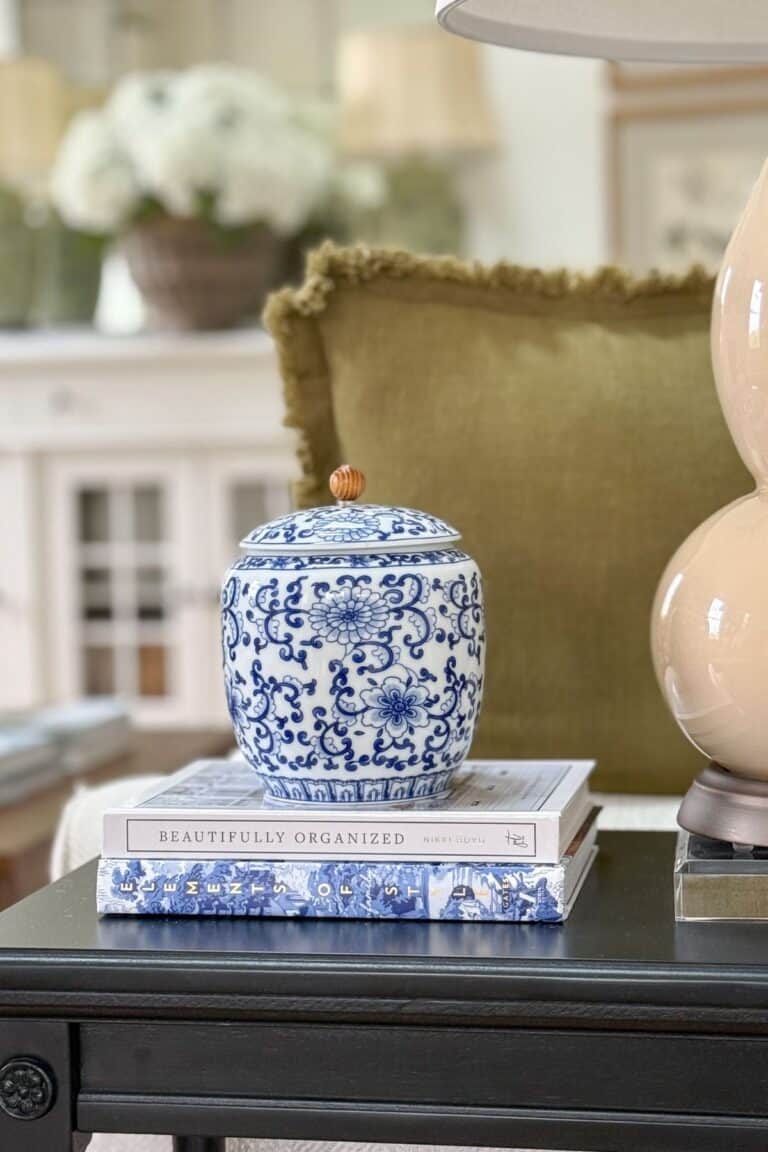 chinoiserie lidded container with a wooden knob on books