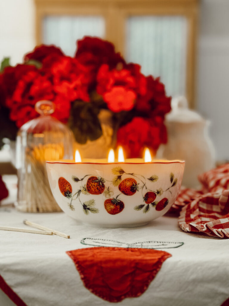 candle bowl with strawberries painted on it.