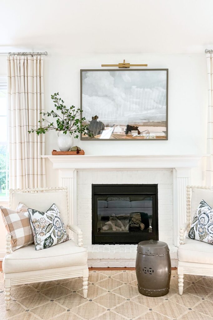 asymmetrical arrangement on a white mantel