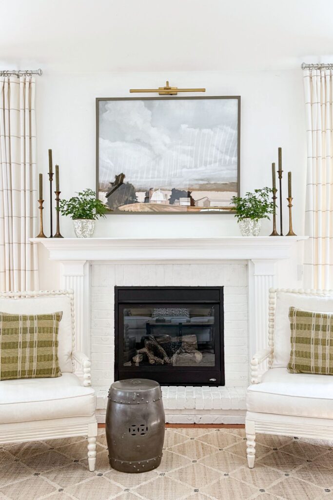 decor on the mantel mimicing the colors in the mantel and pillows on chair