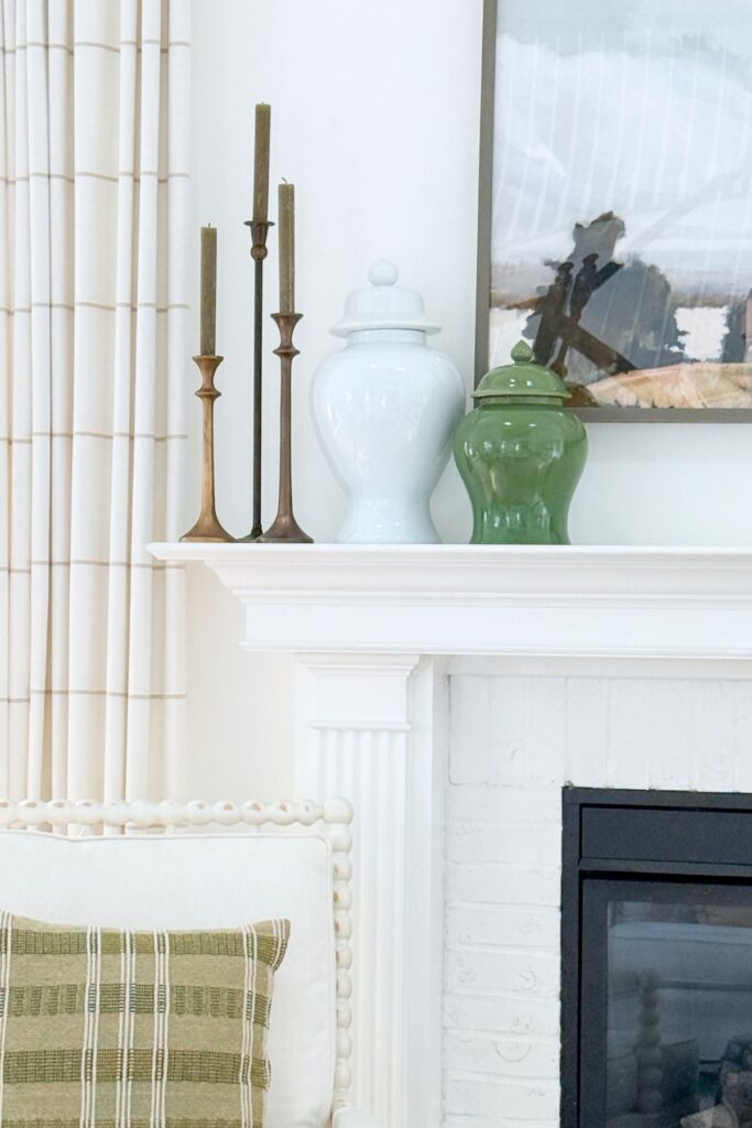living room mantel- large painting and a white and green ginger jar + candles