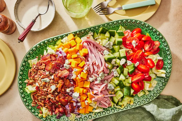 a chopped salad on a festive green plate
