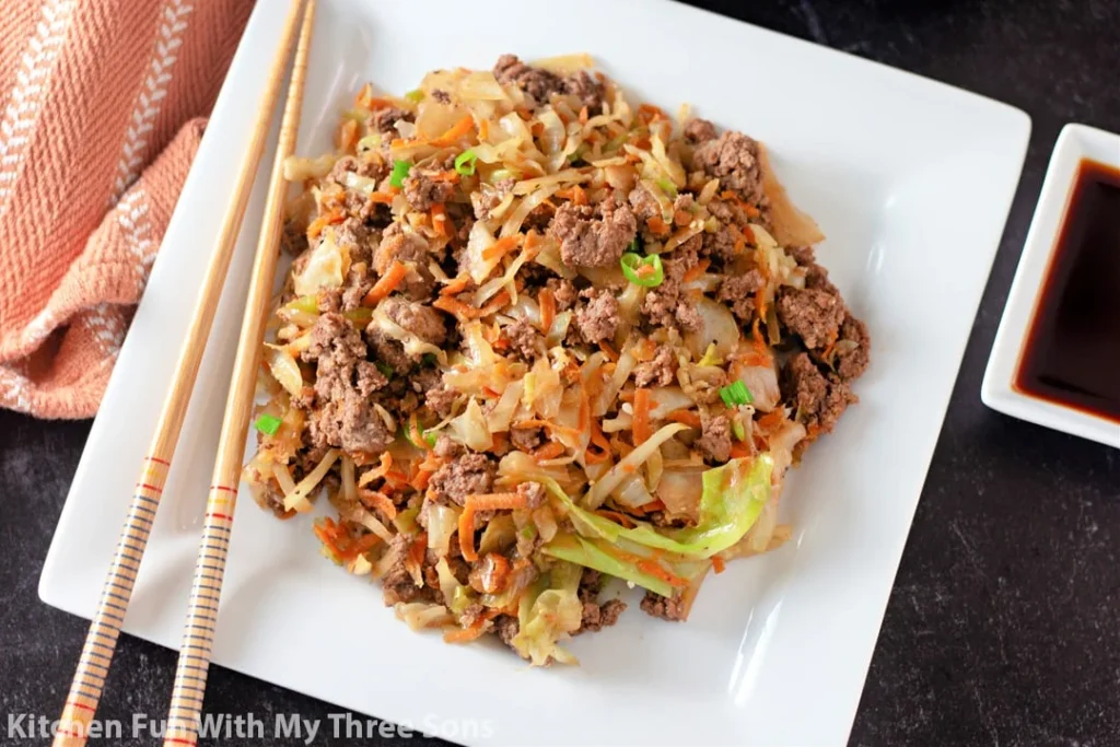 egg roll in a bowl on a white plate with chopsticks