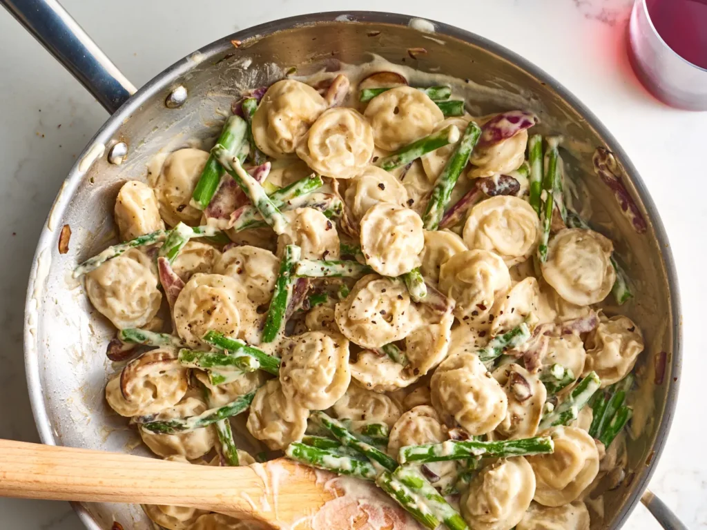 dumplings, mushrooms, and asparagus in a creamy sauce.