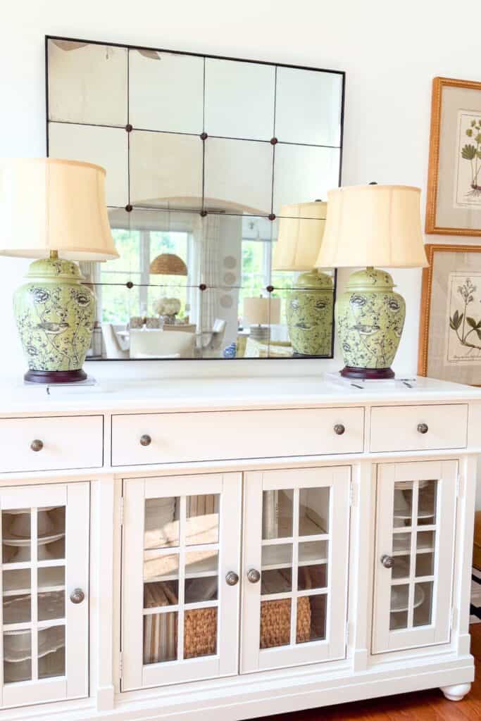 White buffet styled with only a pair of green chinoiserie lamps before a midsummer decorating refresh