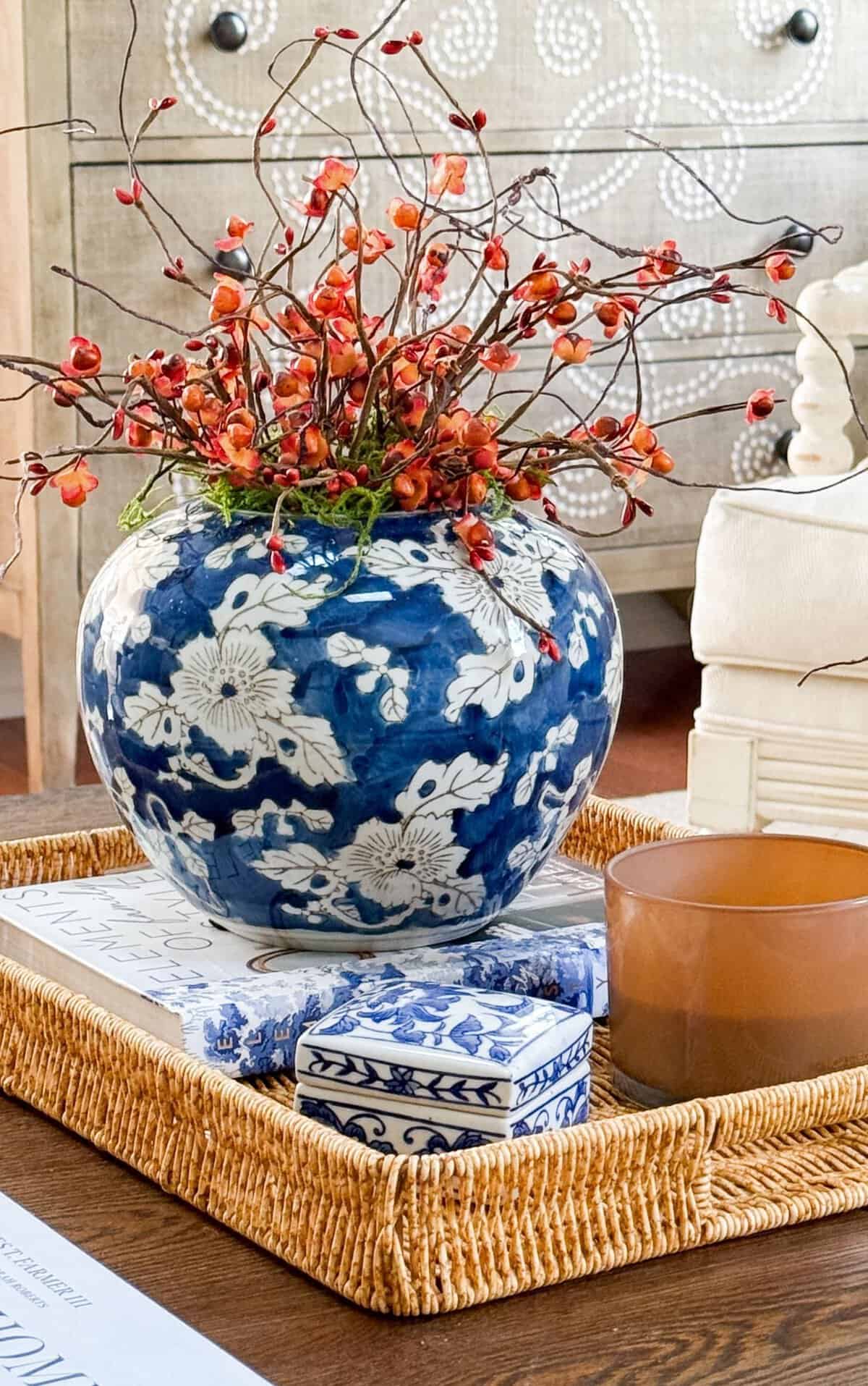 bittersweet in a chinoiserie vase on a coffee table