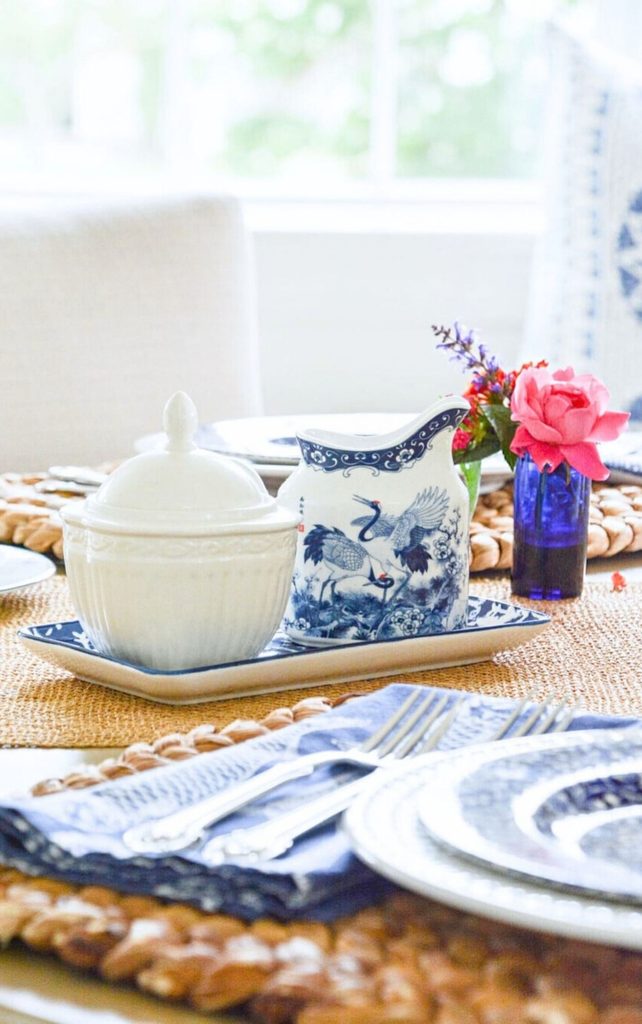 blue and white dishes on a round table