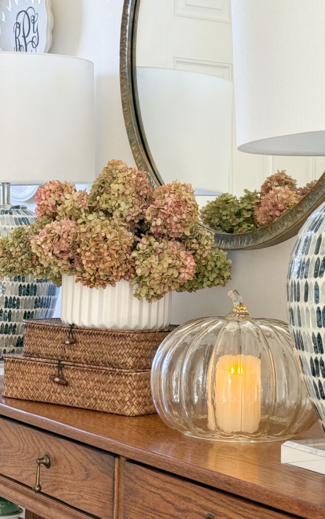 dried hydrangeas on a pair of boxes and a glass pumpkin