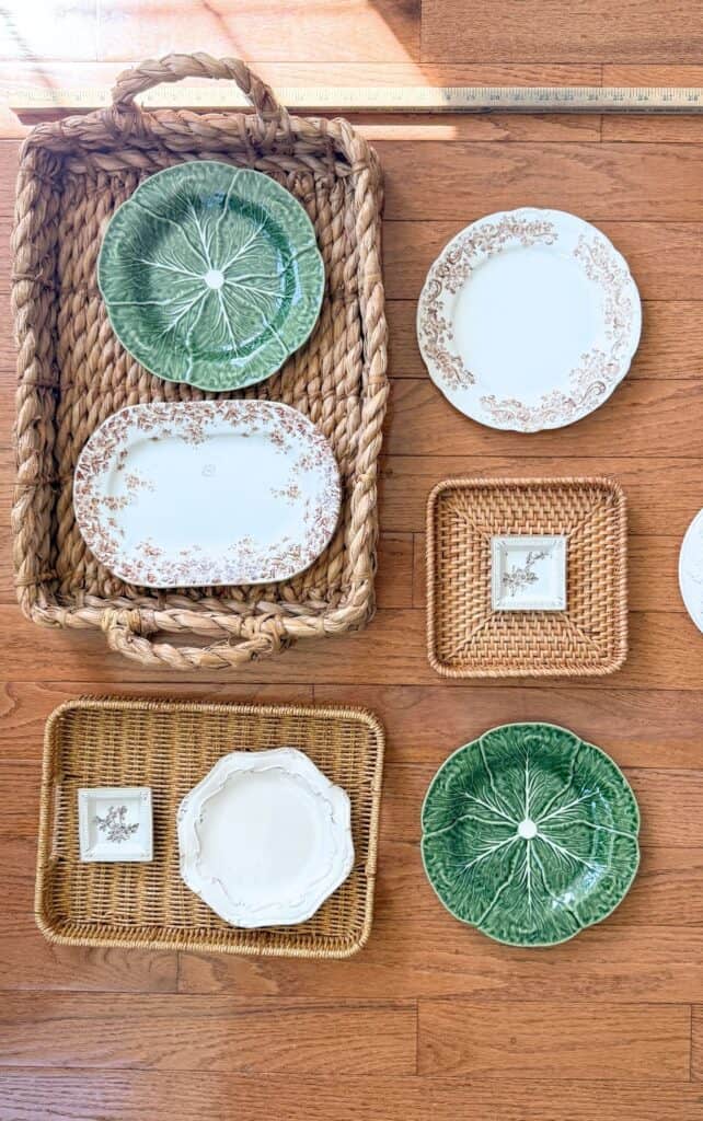 Baskets and plates laid out on the floor with a ruler to plan wall spacing