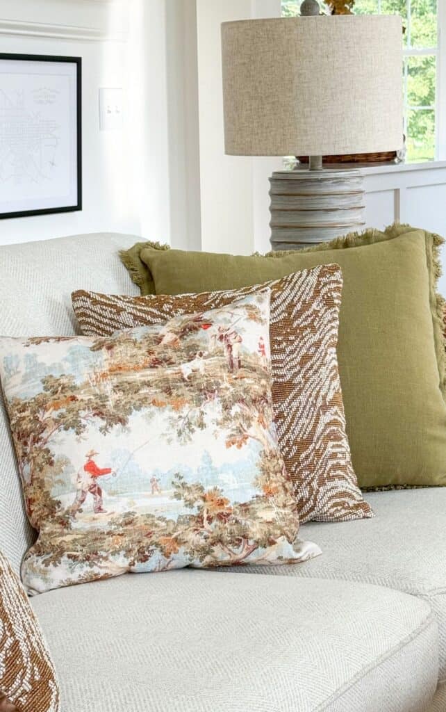 trio of fall pillows on a sofa