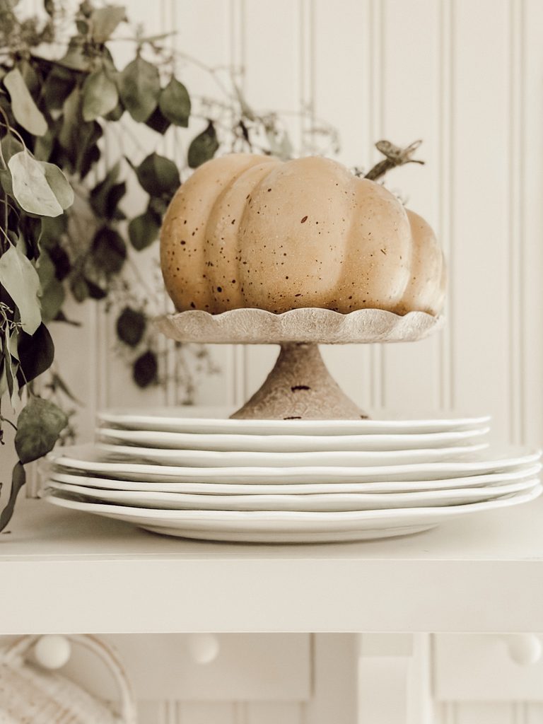 pumpkin on a scalloped pedestal